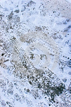 Foots and tire prints on the snow.