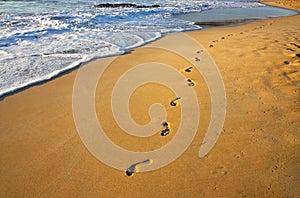 Footsteps on the beach and water