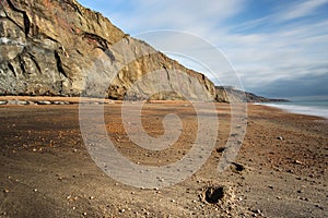 Footsteps lead along the deserted beach at Whale Chine in The Isle of Wight