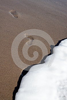 Footsteps in the Sand fading away