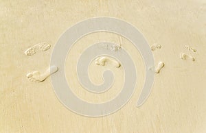 Footsteps at the sand on the seaside