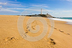 Footsteps on the sand at Zahora Beach leading to Trafalgar lighthouse photo