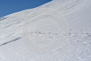 Footsteps in the snow in the high mountains photo