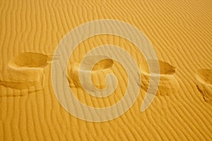 Footsteps on the texture of sand dunes