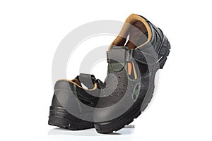 Footwear concept. Men`s boots of black and orange colour isolated on white background