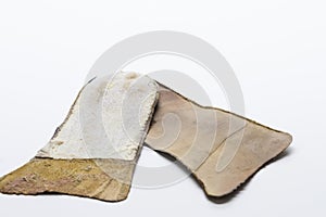 Footwear Concepts. Closeup of Pair of Brown Used Removable Shoe Insoles Placed Over White Background