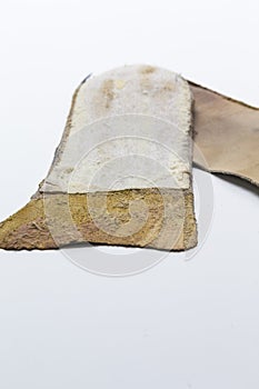 Footwear Concepts. Closeup of Pair of Brown Used Removable Shoe Insoles Placed Over White Background