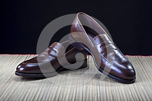 Footwear Concepts and Ideas. Pair of Stylish Expensive Modern Calf Leather Brown Penny Loafers Shoes