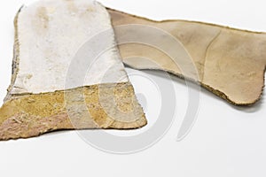 Footwear Concepts. Texture Closeup of Pair of Brown Used Removable Shoe Insoles Placed Over White Background