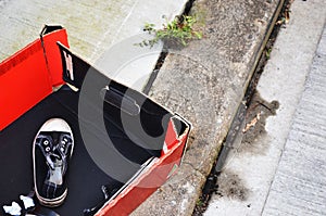 Sneaker in red box on kerbside photo