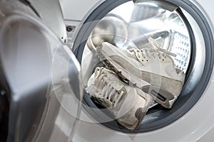 footwear hygiene - pair of white sneakers in the washing machine