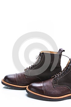 Footwear Ideas. Closeup of Premium Dark Brown Grain Brogue Derby Boots Made of Calf Leather with Rubber Sole Placed in Line