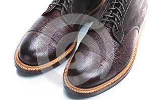 Footwear Ideas. Extreme Closeup of Toes of Premium Dark Brown Grain Brogue Derby Boots Made of Calf Leather with Rubber Sole