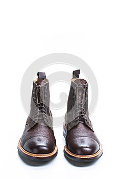 Footwear Ideas. Premium Dark Brown Grain Brogue Derby Boots Made of Calf Leather with Rubber Sole Isolated Over White