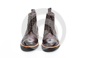 Footwear Ideas. Premium Dark Brown Grain Brogue Derby Boots Made of Calf Leather with Rubber Sole Isolated Over White Background