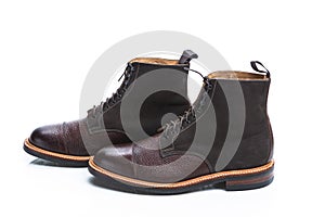 Footwear Ideas. Premium Dark Brown Grain Brogue Derby Boots Made of Calf Leather with Rubber Sole Placed in Line Together Over