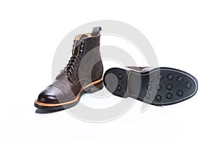 Footwear Ideas. Premium Dark Brown Grain Brogue Derby Boots Made of Calf Leather with Rubber Sole Placed With Sole Exposed Over