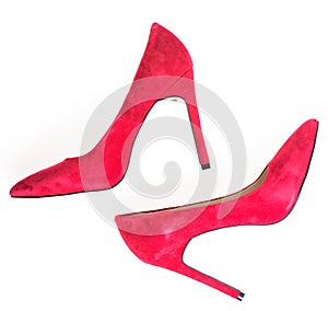 Footwear with thin high heels, stiletto shoes, top view. Red high heel women shoes isolated on white background. Luxury