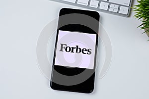 Forbes logo on a smartphone screen