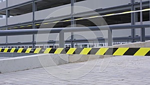 Forbidden black and yellow tape hanging as barrier in multilevel car parking