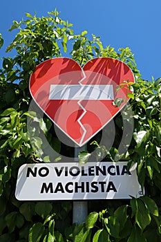 Forbidden sign in the shape of a heart with the text NO SEXIST VIOLENCE