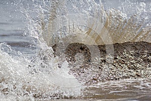 Force of nature. Splashing wave energy. Splash as sea water hits photo