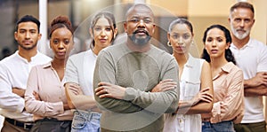 A force that will not be silenced. Portrait of a group of businesspeople with arms folded at the office.