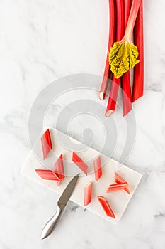 Forced Rhubarb Pieces with Knife and Rhubarb Stalks with Leaf