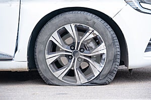 Forced stop car roadside with flat tire punctured tire waiting for tire fitting