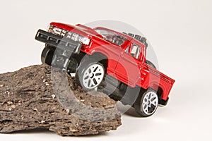 Ford 4x4 Pickup Climbing a Rock