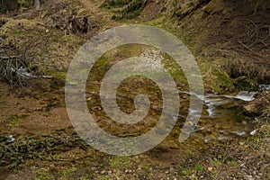 Ford on creek in spring day in Krusne mountains