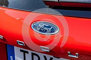 Ford logo on the back of a race red Ford Focus..