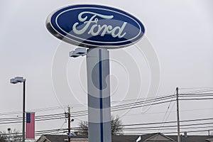 The Ford Motor Company logo as seen on a tall sign at a car dealership. Ford`s headquarters are in Dearborn, Michigan