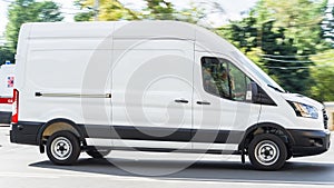 Ford Transit Fourth generation in the city street. Side view of white light commercial vehicle