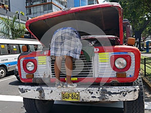 Ford truck engine being repaired by its driver in Lima