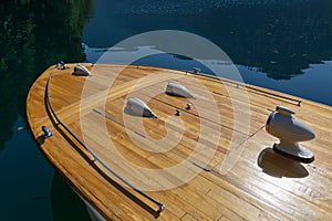 Fore part of a rarity wooden boat against the background of the clear water of the lake