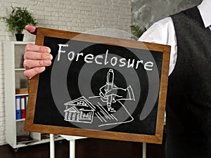 Foreclosure Home For Sale Real Estate inscription on the piece of paper