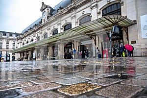 Forecourt of railroad station with little train traffic and people on a rainy day photo