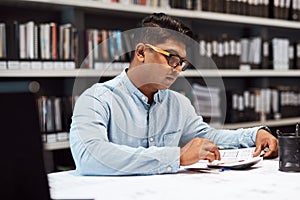 At the forefront of fine building design. a young architect drawing up a building plan in a modern office.