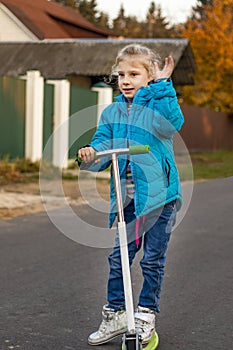 foreground. a girl with white hair and in a blue jacket riding a scooter. and moshet us hand