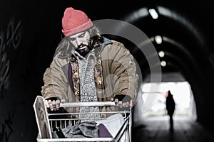 Hopeless drifter with trolley photo