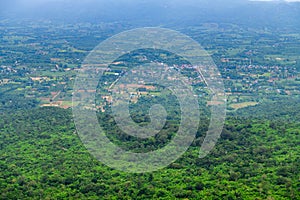 The foreground view from a viewpoint in Sai Thong National Park, Thailand, overlooks green forest nature and city of Chaiyaphum