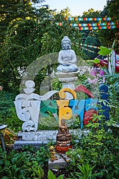 Foreign colorful letters and Buddha statues in prayer and meditation garden for Tibetan Mongolian Buddhist shrine