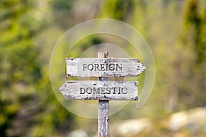Foreign domestic text carved on wooden signpost outdoors in nature. photo
