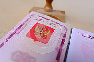 foreign, International biometric passports of citizen of Russian Federation with red cover on light background, stamp. Stop