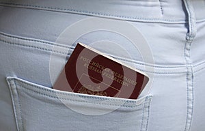 Foreign passport of the Russian Federation sticks out of the back pocket of jeans