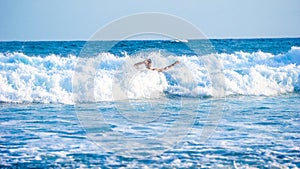 Foreign tourists play with the waves at Gondo Mayit Beach