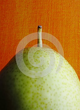 Forelle Pear against orange background