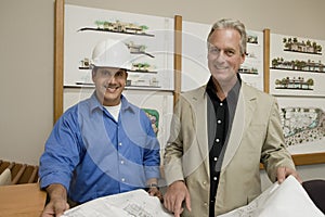 Foreman With Client Holding Blueprint photo