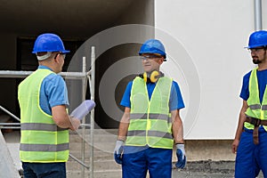 The foreman on the construction site talks to the workers